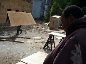 Art Abanton, in foreground, oversees workers at the Westville site Friday.