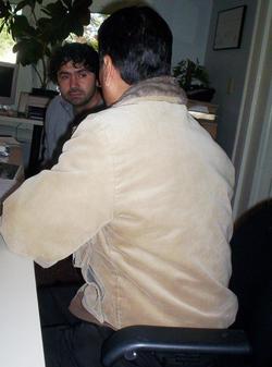 John Lugo listens as Manuel, with back to camera, tell his story of coming north and working on the Arts Lofts West job.
